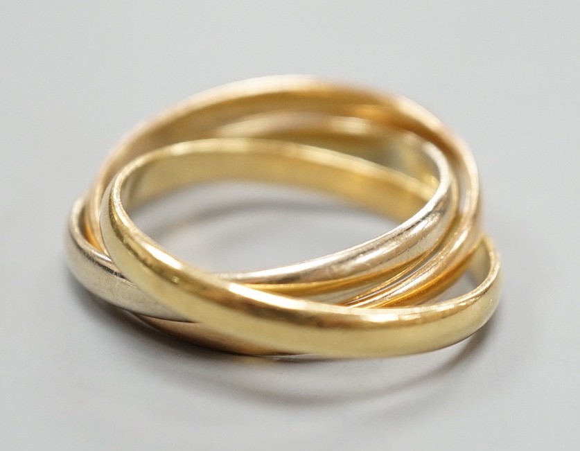 A modern Cartier three colour 750 yellow metal 'Russian' triple wedding ring, size U, 8.5 grams.